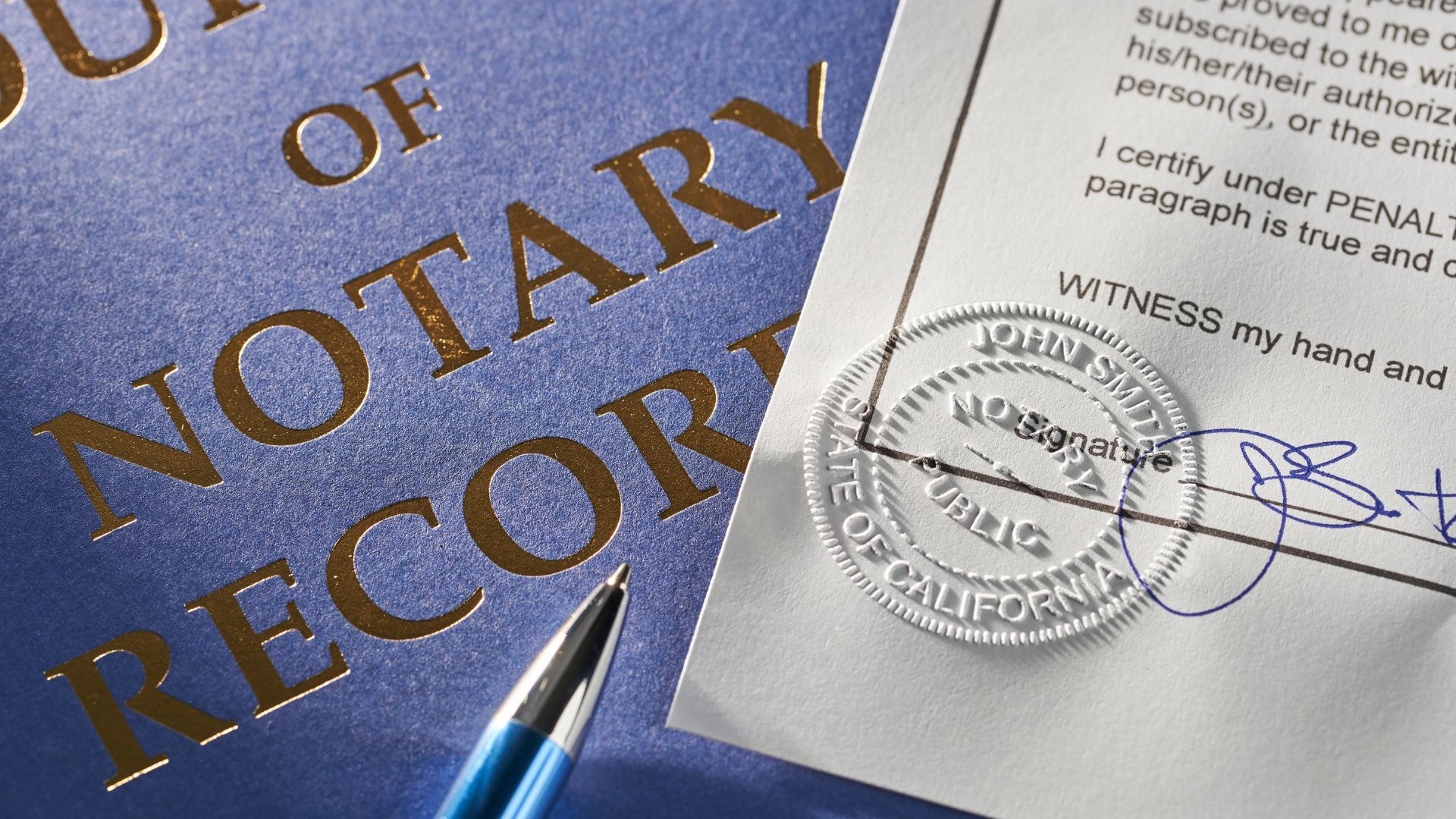 Notary document with official seal, pen, and gold lettering on blue background